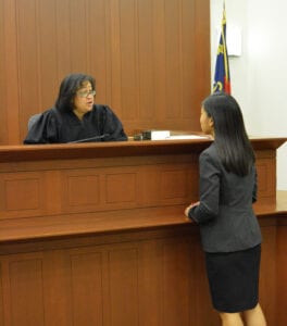 Interns page Intern speaking with a judge